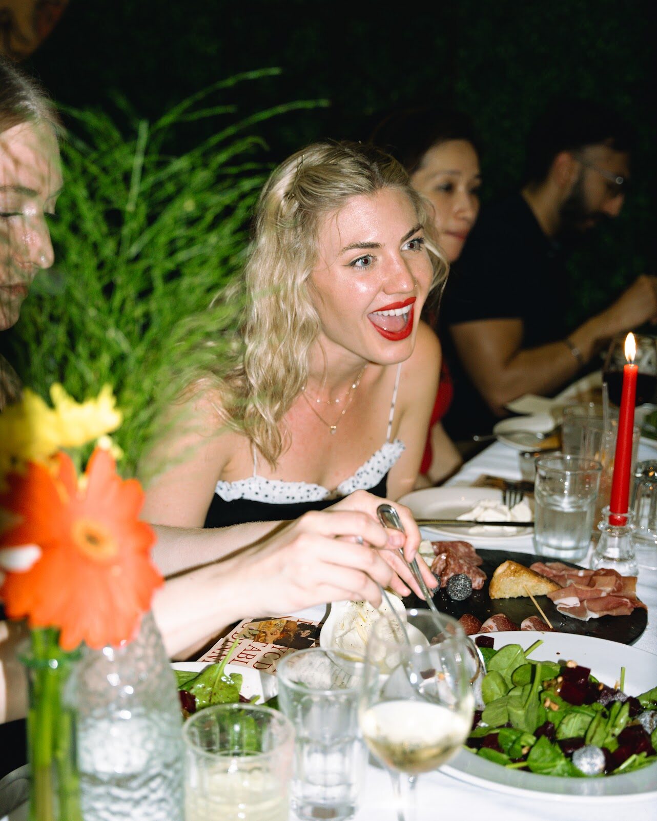 A guest laughing at dinner